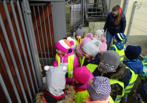 Dzieci przy małym piesku podczas wycieczki do Schroniska dla Bezdomnych Zwierząt w Radomsku.